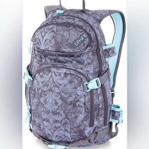 Grey Dakine snowboarding backpack with paisley detail and teal hardware. Womens